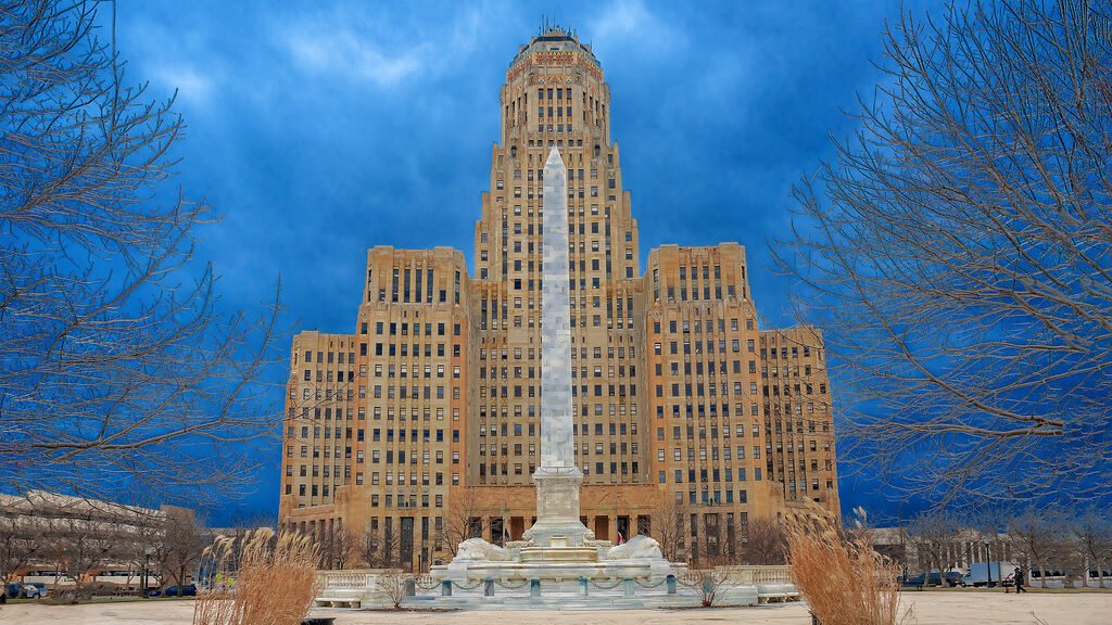 A magnificent edifice, featuring a clock tower, set against the scenic backdrop of an obelisk. Pest control in Buffalo
