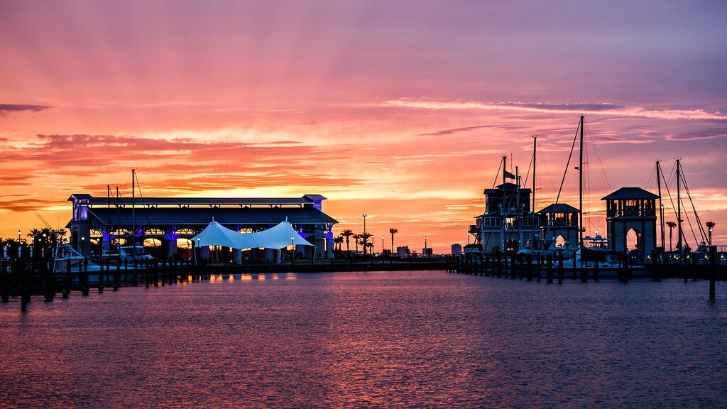 Scenic sunset over water with bridge, creating a tranquil and picturesque setting. Pest control in Gulfport keeps the city clean.